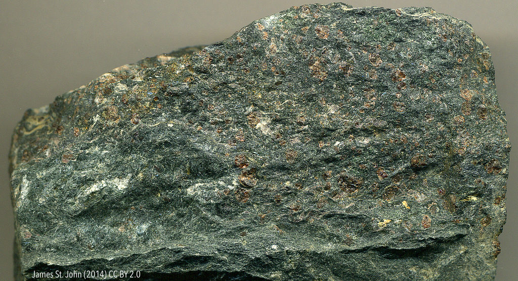 Eclogite from the Swiss-Italian Alps. Reddish brown spots are garnets. _Source: James St. John (2014) CC BY 2.0 [view source](https://flic.kr/p/oHFd9D)_