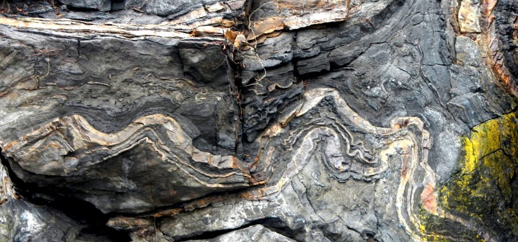 Limestone, a sedimentary rock formed in marine waters, has been altered by metamorphism into this marble visible on Quadra Island, BC. _Source: Steven Earle (2015) CC BY 4.0 [view source ](https://opentextbc.ca/physicalgeologyearle/wp-content/uploads/sites/145/2016/06/limestone2.jpg)_