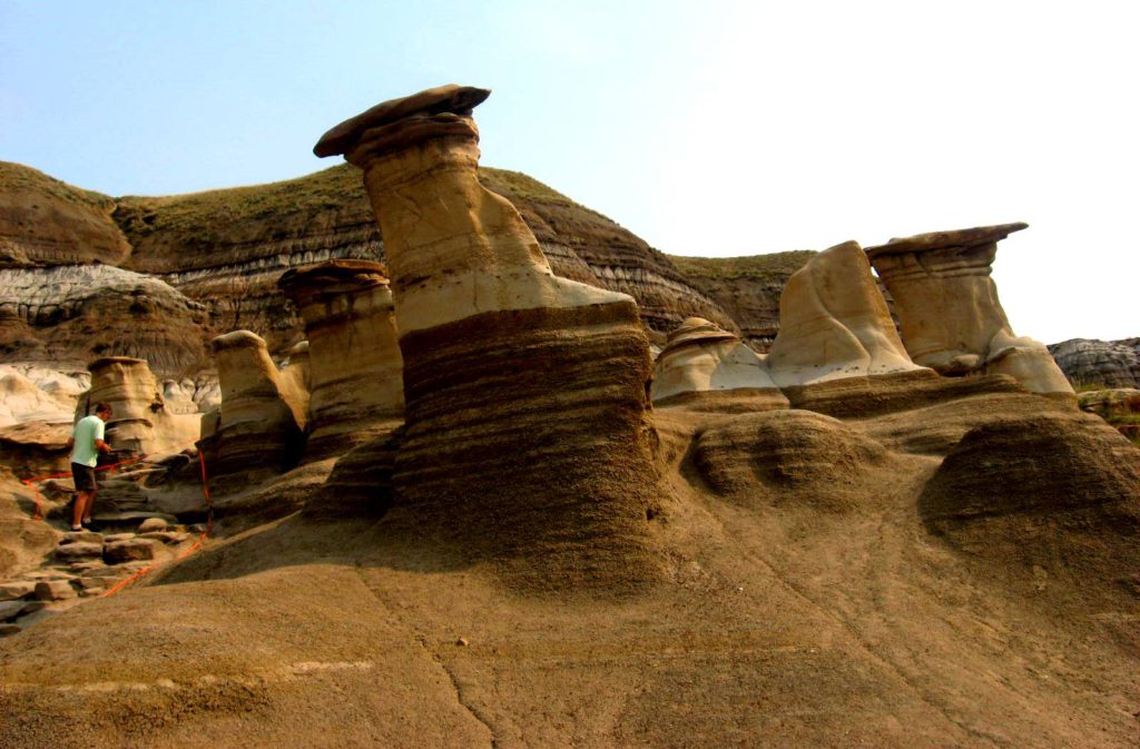 The Hoodoos, near Drumheller, Alberta, have formed from the differential weathering (weaker rock weathering faster than stronger rock) of sedimentary rock. _Source: Steven Earle (2015) CC BY 4.0 [view source](https://opentextbc.ca/geology/wp-content/uploads/sites/110/2015/07/image002.png)_