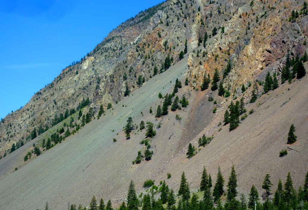 An area with very effective frost wedging near Keremeos, BC. The fragments that were wedged away from the cliffs above have accumulated in a talus deposit at the base of the slope. The rocks in this area are variable in colour, which is reflected in the colours of the talus. _Source: Steven Earle (2015) CC BY 4.0 [view source](https://opentextbc.ca/geology/wp-content/uploads/sites/110/2015/07/image011.jpg)_
