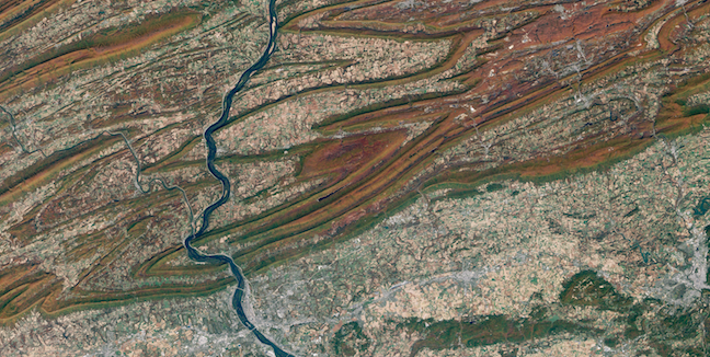 Ridges and valleys in central Pennsylvania formed from weathered and eroded folds. The V-shapes indicate the folds are plunging. _Source: NASA on the Commons (2001) Public Domain [view source](https://flic.kr/p/pzkX9K)_