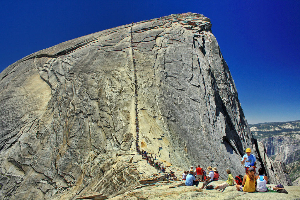Half Dome at Yosemite National Park is an exposed granite batholith that displays exfoliation joints, causing sheets of rock to break off. _Source: HylgeriaK (2010) CC BY-SA 3.0 [view source](https://commons.wikimedia.org/wiki/File:Half_dome_yosemite_nationalpark_t1.JPG)_