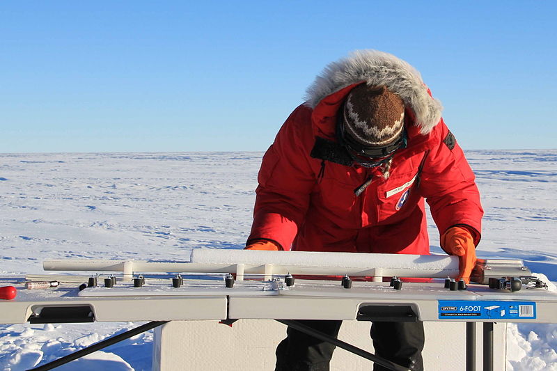 A scientist weighs and measures a cylinder of core from the West Antarctic Ice Sheet before she packages it for transport. _Source: NASA/Lora Koenig (2010) CC BY 2.0 [view source](https://flic.kr/p/9h8E9k)_