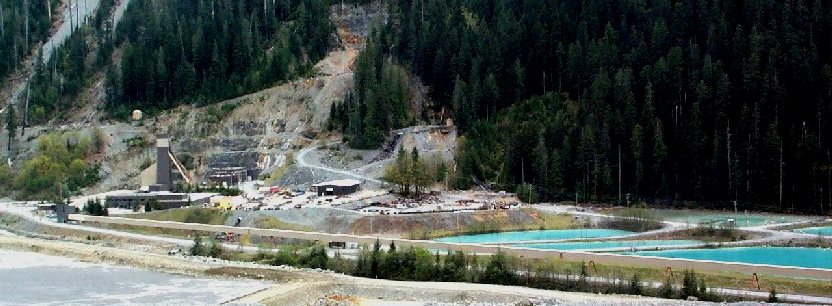 The tailings pond (lower left) at Myra Falls Mine with settling ponds (right) for processing water from the concentrator. [SE]